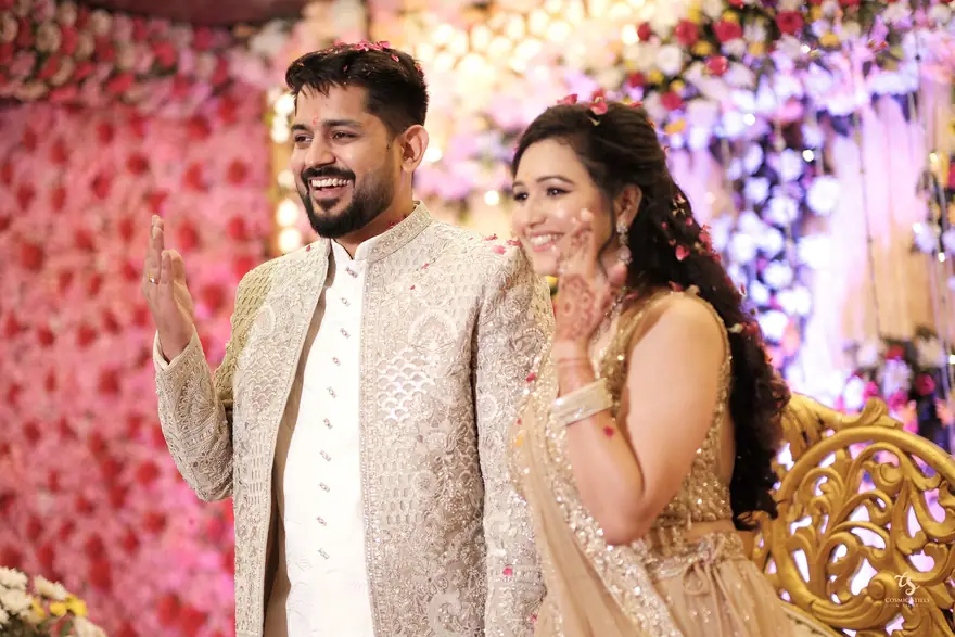 The couple waving with petals in the air