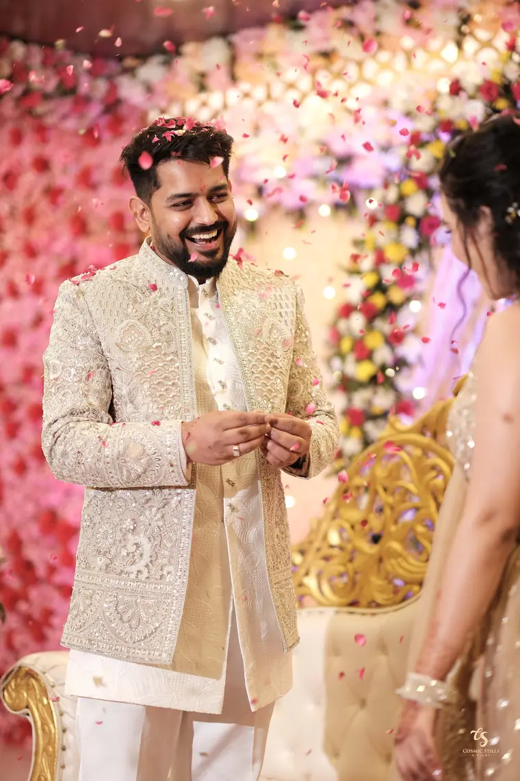 Akshay laughing under a shower of rose petals