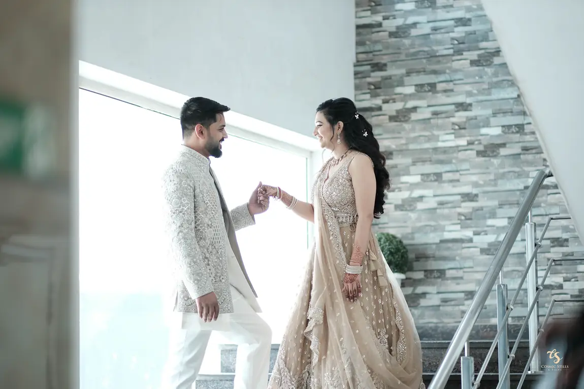 Akshay reaching for Nishtha's hand on a staircase
